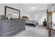 Bedroom with neutral tones, wooden bed frame, dresser, lamps and plenty of light from the windows at 4029 Cascades Thrust, Summerville, SC 29483