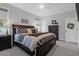 Well-lit bedroom featuring a dark wood bed frame, a ceiling fan, and neutral colored walls at 4029 Cascades Thrust, Summerville, SC 29483