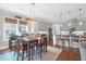 Bright dining area with wood table, seating for six, and adjacent kitchen with stainless appliances at 4029 Cascades Thrust, Summerville, SC 29483
