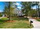 Landscaped front yard with a manicured lawn and private driveway leading to a charming home at 4029 Cascades Thrust, Summerville, SC 29483