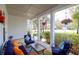 Inviting front porch with comfortable seating, colorful cushions, and charming floral accents at 4029 Cascades Thrust, Summerville, SC 29483