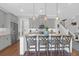 Well-lit kitchen with stainless steel appliances, a kitchen island with seating, and stylish gray cabinetry at 4029 Cascades Thrust, Summerville, SC 29483