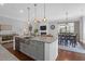 Spacious kitchen island with pendant lighting, stainless steel sink, and open layout to the dining and living areas at 4029 Cascades Thrust, Summerville, SC 29483