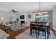Open-concept living area with a fireplace, TV, and comfortable seating that flows into dining space at 4029 Cascades Thrust, Summerville, SC 29483