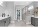 Modern main bathroom with gray cabinets, double vanity, a glass shower, and tile floors at 4029 Cascades Thrust, Summerville, SC 29483