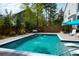 Backyard pool with in-water loungers and travertine deck offers a serene oasis for relaxation and enjoyment at 4029 Cascades Thrust, Summerville, SC 29483