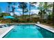 Backyard pool with submerged loungers and lush greenery provides a private and refreshing escape at 4029 Cascades Thrust, Summerville, SC 29483