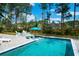 Backyard pool with submerged loungers and a cozy seating area creates a relaxing outdoor space at 4029 Cascades Thrust, Summerville, SC 29483