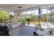 Relaxing screened porch with comfortable seating and view of the beautifully landscaped backyard at 4029 Cascades Thrust, Summerville, SC 29483