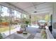 Bright screened porch with a ceiling fan, comfortable seating, and view of the pool area at 4029 Cascades Thrust, Summerville, SC 29483