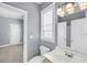Well lit bathroom featuring a modern sink, mirror and light fixtures, with light gray paint and white trim at 412 Hydrangea St, Summerville, SC 29483
