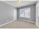 Cozy bedroom with neutral carpet, light gray walls, white trim and baseboards, and a large window at 412 Hydrangea St, Summerville, SC 29483