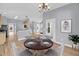 Open-concept dining area featuring hardwood floors and seamless flow to kitchen and living spaces at 412 Hydrangea St, Summerville, SC 29483