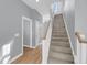 Bright entryway with hardwood floors leading to a carpeted staircase and white trim at 412 Hydrangea St, Summerville, SC 29483