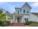 Charming two-story home featuring a welcoming front porch, light blue siding, and well-maintained landscaping at 412 Hydrangea St, Summerville, SC 29483
