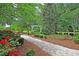 A beautiful garden path leads to a gazebo surrounded by lush greenery and vibrant red roses at 412 Hydrangea St, Summerville, SC 29483