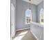Upstairs hallway with unique arched windows and neutral carpeting at 412 Hydrangea St, Summerville, SC 29483