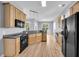Spacious kitchen with wooden cabinets, black appliances, and hardwood flooring at 412 Hydrangea St, Summerville, SC 29483