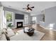 Bright living room with hardwood floors, fireplace, and open layout to dining area at 412 Hydrangea St, Summerville, SC 29483