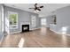 Bright, open living room with fireplace, ceiling fan, and beautiful hardwood floors at 412 Hydrangea St, Summerville, SC 29483