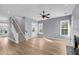 Spacious living room featuring a staircase, hardwood floors, and a ceiling fan at 412 Hydrangea St, Summerville, SC 29483