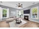 Well-lit living room boasting fireplace, hardwood floors, and expansive windows at 412 Hydrangea St, Summerville, SC 29483