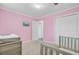 Pink bedroom with white trim, small TV, a large closet, and carpet at 4418 Hardwood St, Ladson, SC 29456