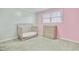 Bright bedroom with a crib, changing table, light grey carpet, and a large window at 4418 Hardwood St, Ladson, SC 29456