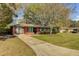 Inviting single-story brick home with a long driveway and well-kept lawn at 4418 Hardwood St, Ladson, SC 29456