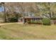 Single-story brick home with landscaped front yard and mature trees at 4418 Hardwood St, Ladson, SC 29456