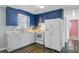 Well-lit kitchen with white cabinets, white appliances and laminate flooring at 4418 Hardwood St, Ladson, SC 29456