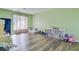 This playroom features a wooden floor and a neutral grey lounge at 4418 Hardwood St, Ladson, SC 29456