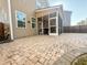 Home's exterior with a brick patio and screened in porch offering an ideal outdoor living space at 449 Whispering Breeze Ln, Summerville, SC 29486