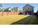 Huge backyard with grass, a brick patio, screened porch, and a wooden fence at 449 Whispering Breeze Ln, Summerville, SC 29486