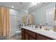 Well-lit bathroom with a shower-tub combo, wood vanity, and ample counter space at 449 Whispering Breeze Ln, Summerville, SC 29486