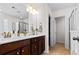 Dual vanity bathroom with tile flooring, white countertops, and framed mirror at 449 Whispering Breeze Ln, Summerville, SC 29486