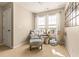 Bedroom with plush chair, side table, two large windows, and neutral color scheme at 449 Whispering Breeze Ln, Summerville, SC 29486