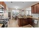 Well-equipped kitchen with granite countertops, wooden cabinets, stainless steel appliances, and an eat-in dining area at 449 Whispering Breeze Ln, Summerville, SC 29486