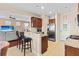 Open kitchen with granite counters, stainless appliances, breakfast bar, and view to adjacent living room with stairs at 449 Whispering Breeze Ln, Summerville, SC 29486