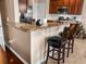 Kitchen island featuring granite countertops and bar stool seating at 449 Whispering Breeze Ln, Summerville, SC 29486