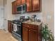 Well-lit kitchen features stainless steel appliances, granite countertops and brown cabinets at 449 Whispering Breeze Ln, Summerville, SC 29486
