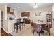 Eat-in kitchen featuring granite countertops, stainless steel appliances, wooden cabinets, and bar stool seating at 449 Whispering Breeze Ln, Summerville, SC 29486