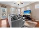 Relaxing living room showcasing a comfortable sectional, a modern entertainment center with a large TV, and natural light at 449 Whispering Breeze Ln, Summerville, SC 29486