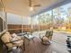 Relaxing screened porch with comfortable seating and views of the backyard at 449 Whispering Breeze Ln, Summerville, SC 29486