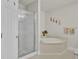 Bright bathroom featuring a glass-enclosed shower and separate soaking tub at 4512 Great Oak Dr, North Charleston, SC 29418