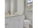 Clean bathroom with white cabinets, sink, and a toilet at 4512 Great Oak Dr, North Charleston, SC 29418