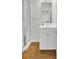 Bathroom featuring glass door shower, white vanity and wood grain flooring at 4512 Great Oak Dr, North Charleston, SC 29418