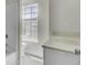 Bright bathroom featuring a bathtub-shower, toilet, and white sink vanity near a window at 4512 Great Oak Dr, North Charleston, SC 29418
