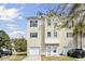 Two story townhome with a front yard, a driveway, a one car garage, and light yellow siding at 4512 Great Oak Dr, North Charleston, SC 29418