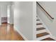 Bright hallway leads to bedroom with hardwood floors and stairs with wooden railing at 4512 Great Oak Dr, North Charleston, SC 29418